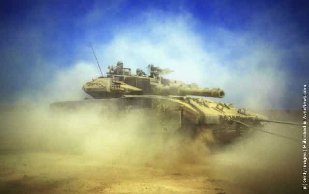 An Israeli tank is pictured at the border between Kibbutz Mefalsim and the Gaza Strip