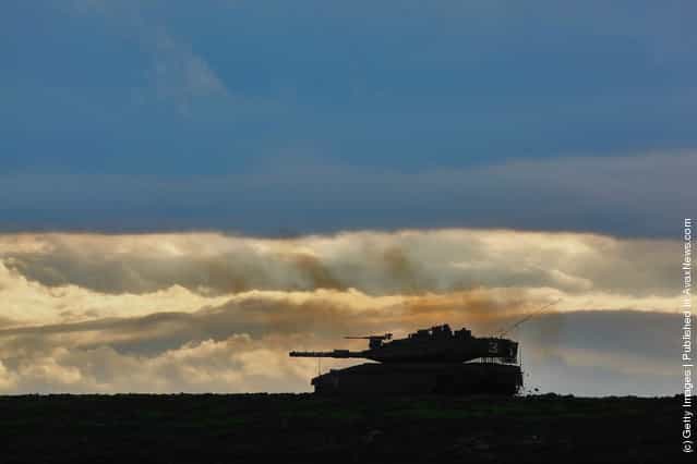 An Israeli army Merkeva tank advances at a firing range