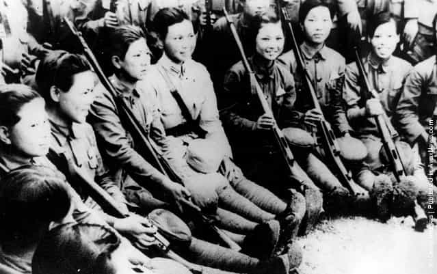 1944: Chinese girls receiving tuition in the use of rifles at their barracks. Over 20,000 girls have so far been trained for service with the Chinese army