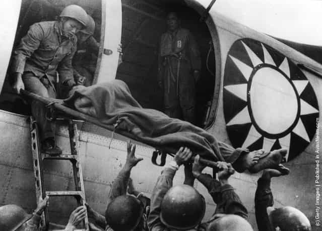 1958: A wounded soldier being flown off the island of Quemoy to Taiwan during a ceasefire between the Nationalist forces and the Chinese Communists