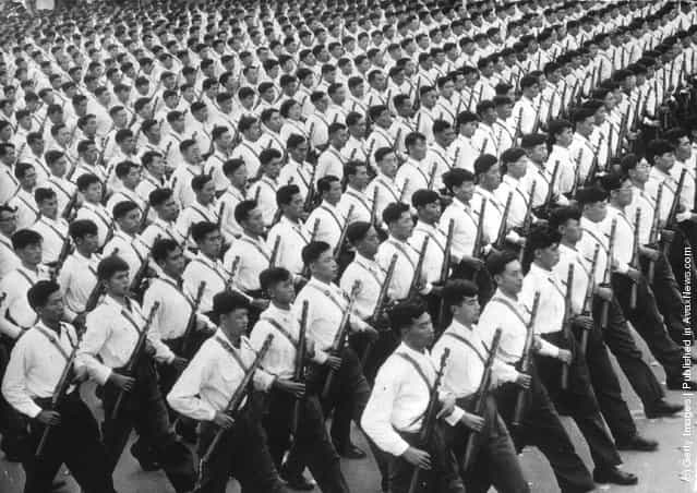 1961: Lines of National Chinese Army marching in Peking with rifles
