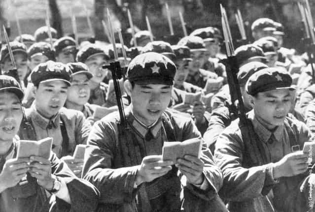 1970: Chinese Red Guards reading from the little red book of Thoughts of Chairman Mao before starting their day