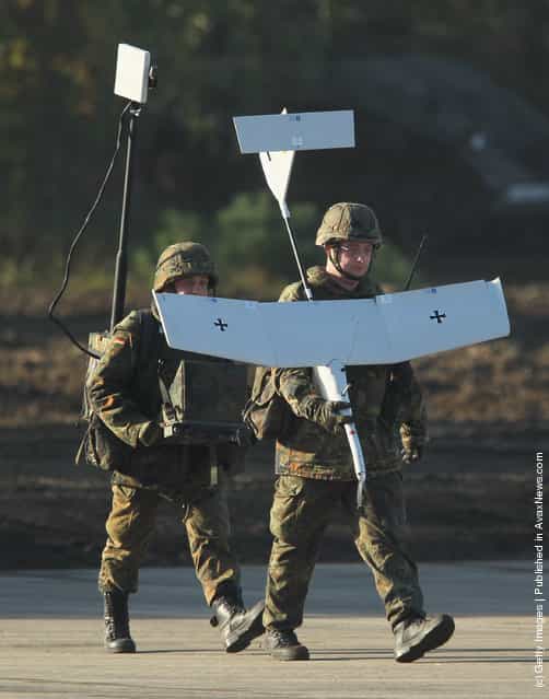 Soldiers hold an Aladin remote controlled reconaissance aircraft of the German Bundeswehr
