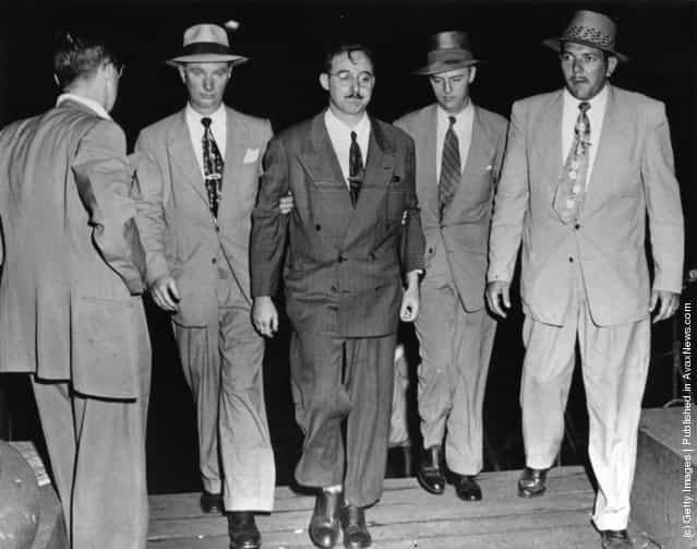 1950: FBI agents escort Julius Rosenberg, a 32 year old engineer (allegedly involved in the Klaus Fuchs-Harry Gold atom bomb spy case), into the FBI building. According to J Edgar Hoover he is another important link in the Soviet espionage apparatus