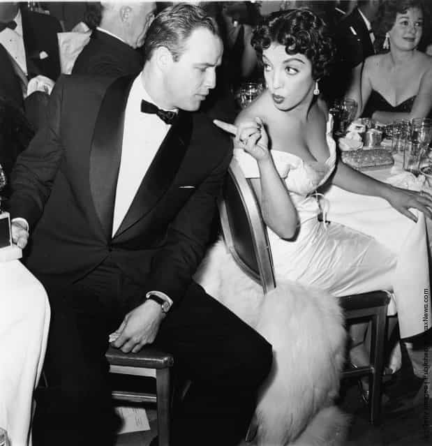 American actor Marlon Brando turns to face Mexican actor Katy Jurado, who gestures at him during a formal awards dinner, 1950s