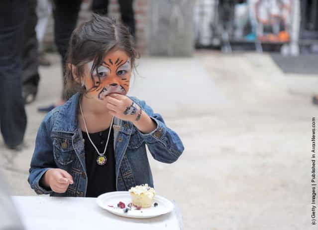 A young girl indulges in a bite to eat during the City Harvest Presents The Brooklyn Local at Tobacco Warehouse