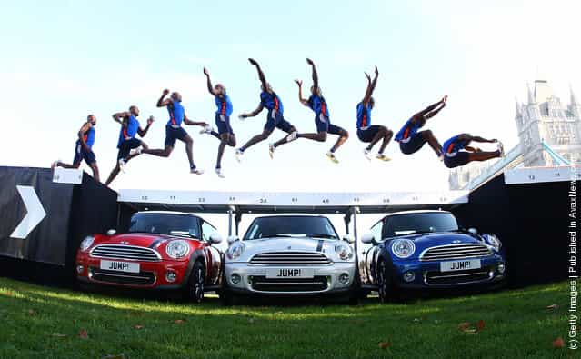 Current England long jump champion and London 2012 hopeful J. J. Jegede attempts an exhibition jump over three Limited edition 2012 MINIs