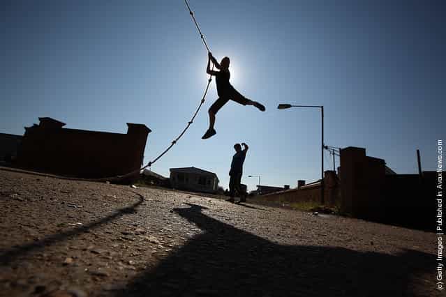 A traveller youth plays on a rope at Dale Farm travellers camp