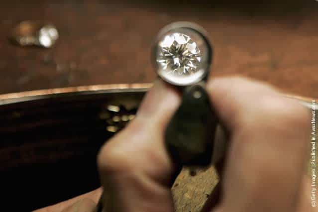 A jeweler examines a brilliant cut 1.01 carat diamond