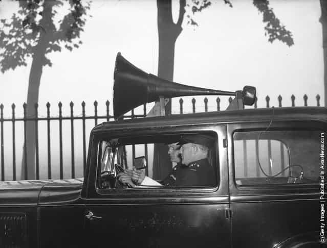 1936: Two police officers patrol the misty streets of London in a new loudspeaker van, providing tips on road safety to drivers and pedestrians