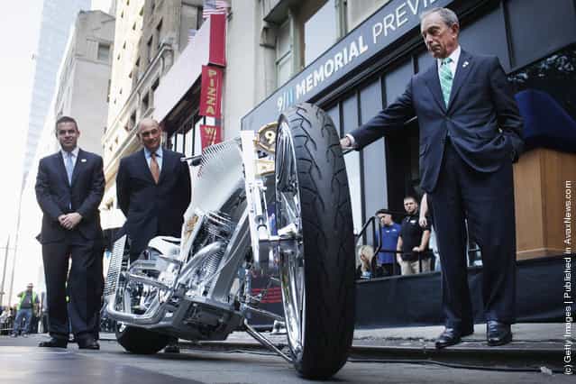 New York Mayor Michael Bloomberg stands near a custom made World Trade Center inspired motorcycle in front of the 9/11 Memorial Preview Site