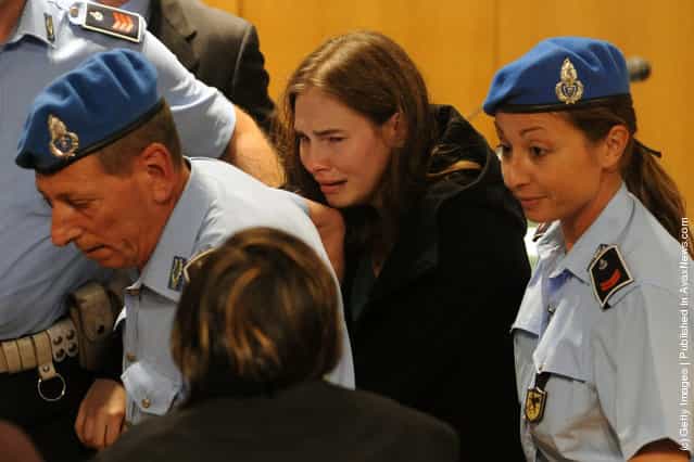 Amanda Knox breaks down in tears after hearing the verdict that overturns her conviction and acquits her of murdering her British roommate