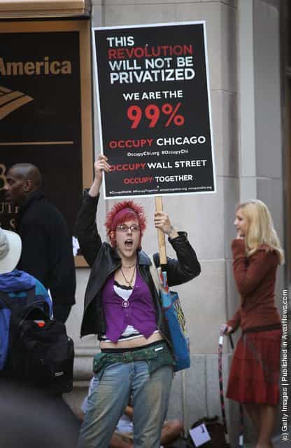 A demonstrator with Occupy Chicago protests outside the Bank of America building