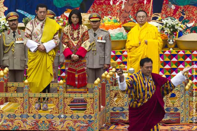 His majesty King Jigme Khesar Namgyel Wangchuck (L), 31, fixes his royal sash during the purification marriage ceremony to Queen Jetsun Pema