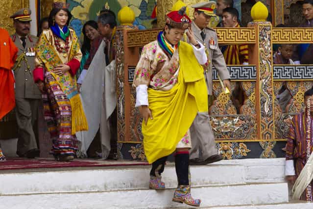 His majesty King Jigme Khesar Namgyel Wangchuck, 31, holds his Raven crown as he and the Queen Jetsun Pema, 21