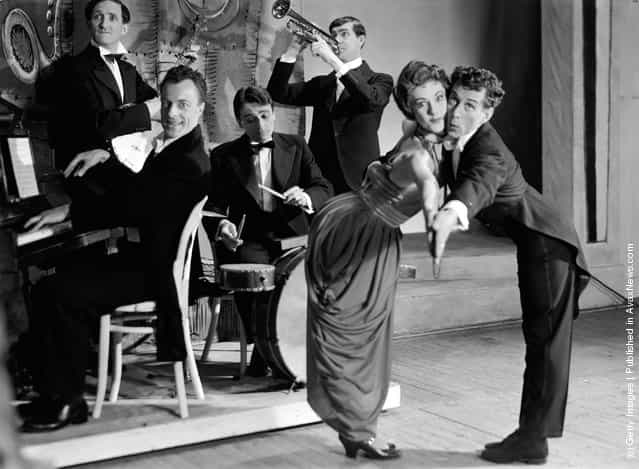 1956: Actors in the drama, For Amusement Only during a band and dancing scene at the Apollo Theatre, London