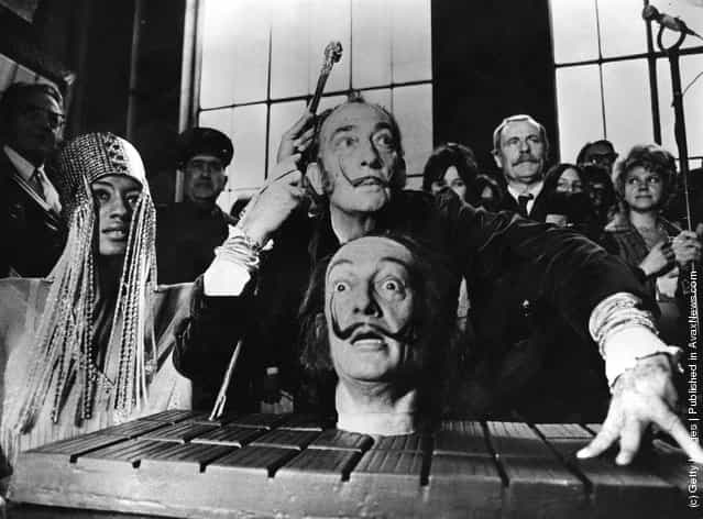 Spanish surrealist painter Salvador Dali with a model of his own head, at a press conference in Paris, 1973