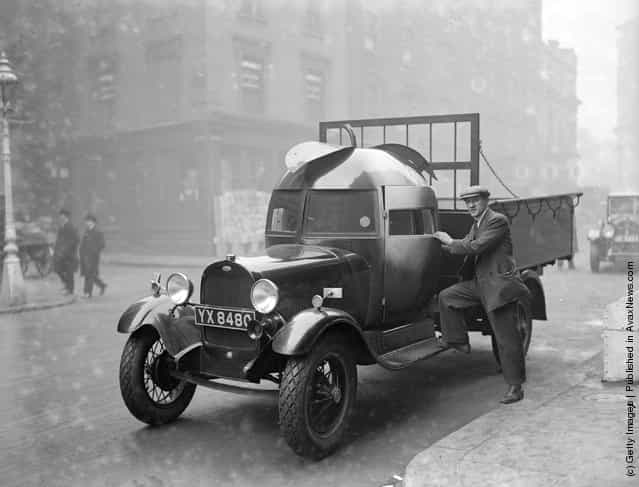 1928: A fruit importers lorry at Covent Garden, London, with its drivers cabin in the shape of an apple