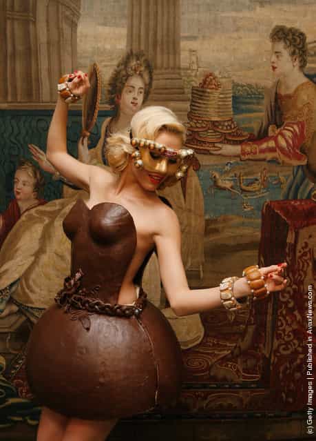 German model Alena Gerber poses wearing a full chocolate dress during the presentation of chocolate dresses
