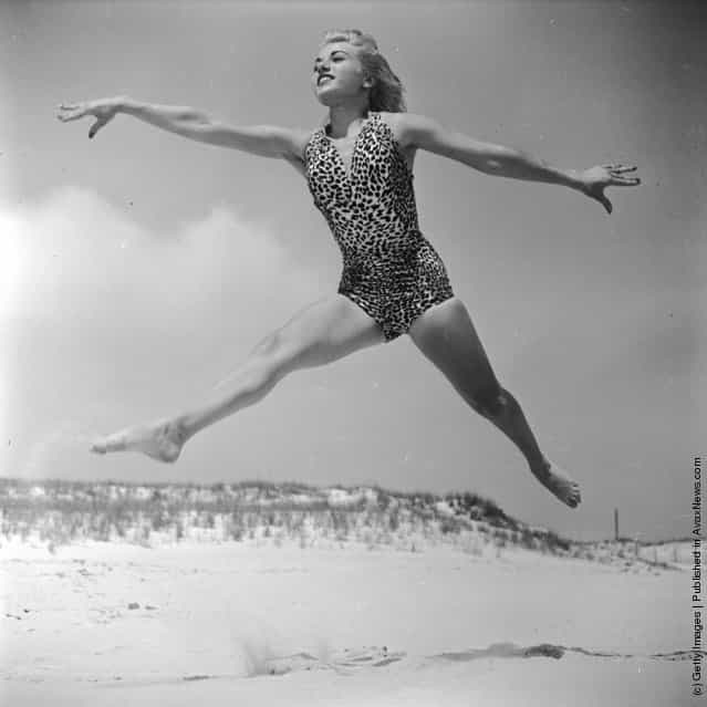 1950: Dancer Ann Argent practices her routine on the beach