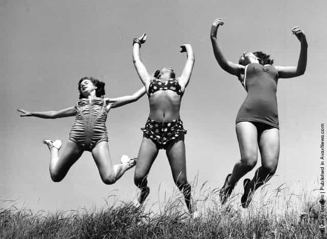 Three Windmill Theatre dancers enjoying the sun on the beach at Angmering during a break in rehearsals, 1952