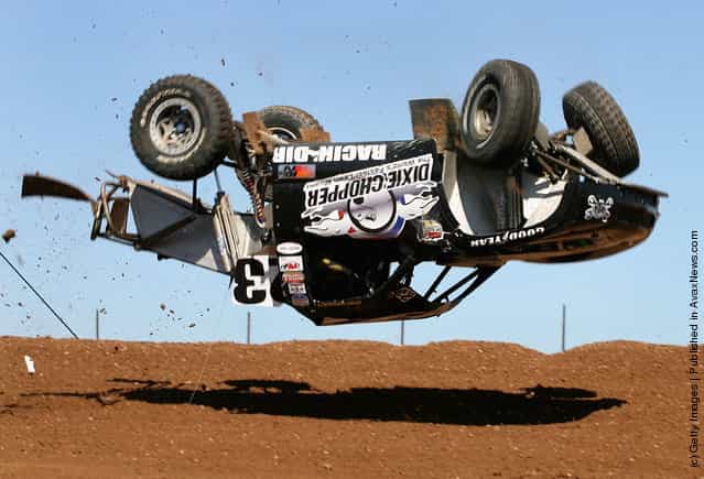 LOORRS unlimited 4 driver Jerry Daugherty flips his truck as he practices in the Lucas Oil Off Road Racing Series