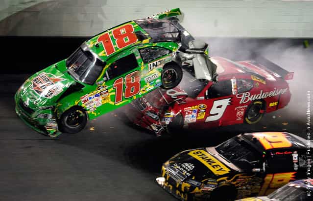 Kasey Kahne, driver of the #9 Budweiser Dodge, crashes into the rear of Kyle Busch, driver of the #18 Interstate Batteries Toyota, after Kyle hit the wall on the final lap during the NASCAR Sprint Cup Series 51st Annual Coke Zero 400 at Daytona International Speedway