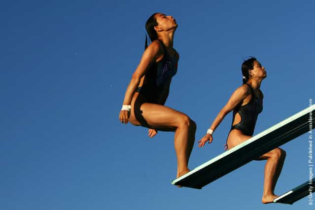 Guo Jingjing and Wu Minxia of China dive during the Synchronized Women Three Meter Final