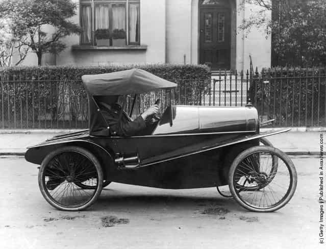 A very early Carden Lightcar being driven along the street, 1916