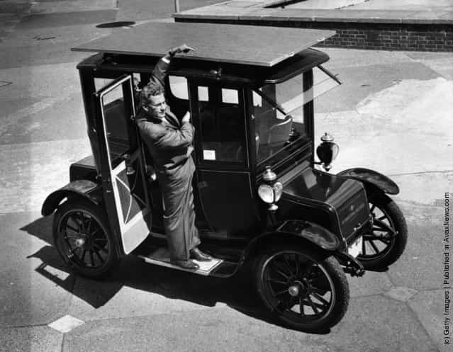 1960: The sun powered car, a 1912 Baker Electric Mode which has been adapted to run from energy obtained from the suns rays. Dr. Charles Alexander Escoffery, the cars inventor, explains the workings of the solar panel