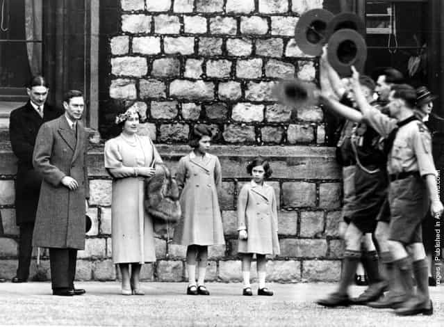 1932: Future King and Queen, George, Duke of York and Elizabeth, Duchess of York with their daughters, Princesses Elizabeth and Margaret Rose (1930 - 2002) of York watching a parade of Boy Scouts at Windsor Castle, Berkshire