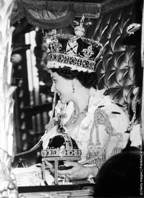 1953: Queen Elizabeth II wearing the State Crown and carrying the State orb in a Royal carriage after her Coronation ceremony