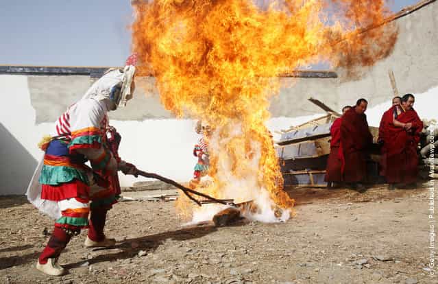 A lama burns a thing symbolizing evil spirits