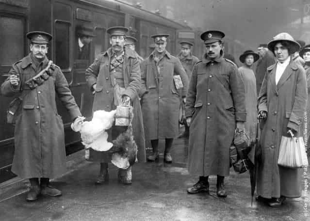 1914: Soldiers, including two recruits who have brought some chickens, at Victoria prepare to board the train for the battle front
