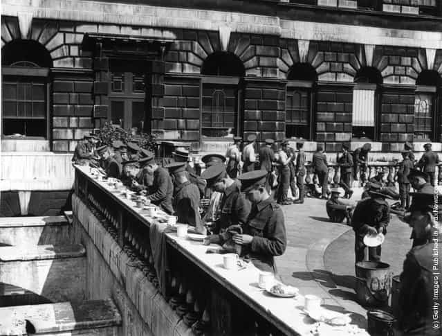 1914: Members of the Territorial army having a meal outside Somerset House, London