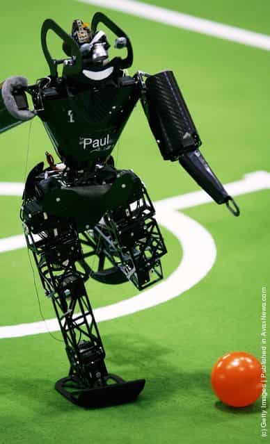 Humanoid robots of the children size league compete during the RoboCup 2006 football world championships