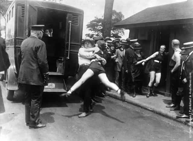 Women in Chicago being arrested for wearing one piece bathing suits, without the required leg coverings, 1922