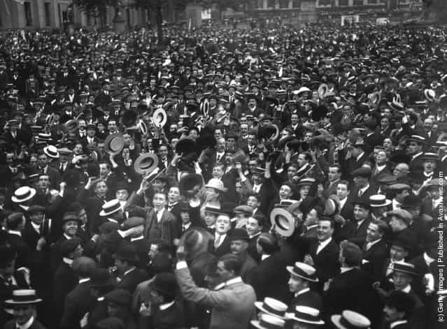 1914: Crowds, many waving boaters, cheer Britains declaration of war on Germany in Trafalgar Square, London