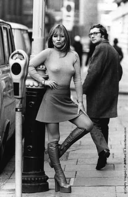 Susan Shaw models a mini skirt and platform boots, 1975