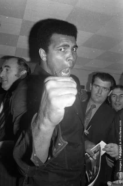 1974: American boxer Muhammad Ali, formerly Cassius Clay, strikes an aggressive pose at a press conference