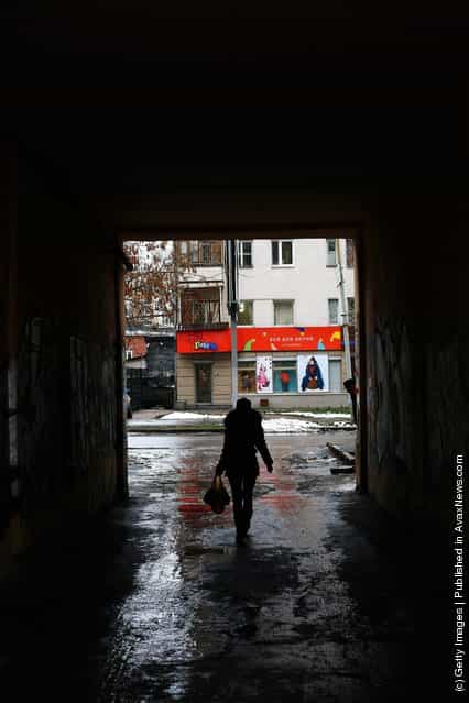 A woman is seen walking down an alleyway in Yekaterinburg, Russia