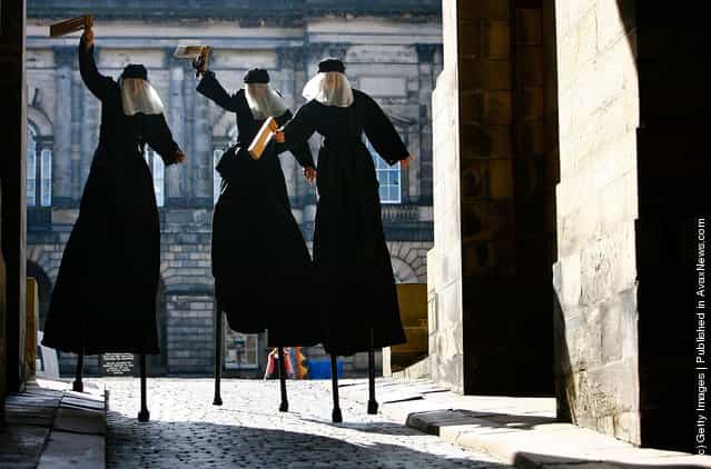 Universal Arts and Polish Cultural Institute perform Macbeth on stilts, near the Royal Mile during the Edinburgh Fringe Festival