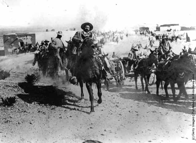 Mexican revolutionary leader General Pancho Villa (1878 - 1923) rides at the head of the Mexican rebels during the Mexican Revolution
