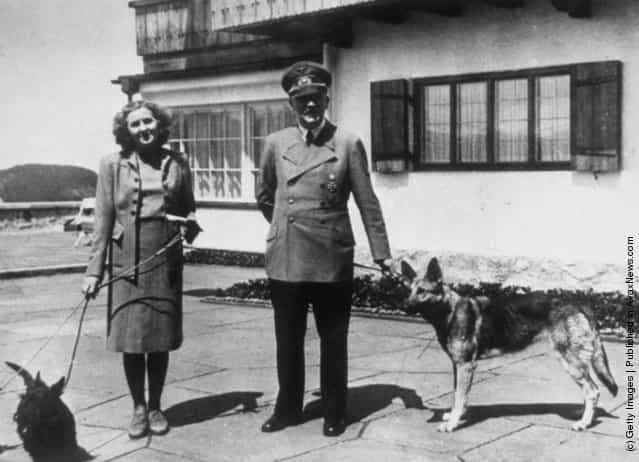 1940: Hitler with Eva Braun, his supposed wife, photographed with their dogs at Berchtesgaden