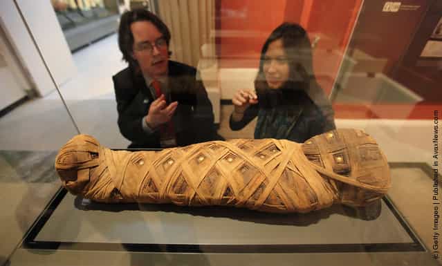 Members of the public view a mummified child dating from 80AD in the Ashmolean Museums new exhibition of artifacts from ancient Egypt and Nubia