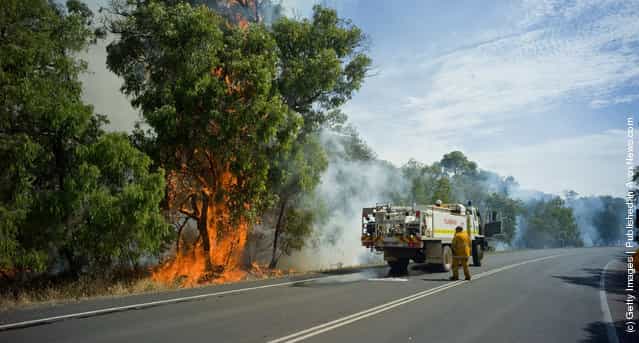 Fire fighters battle a breakout after a bush fire swept through the area in Margaret River, Australia