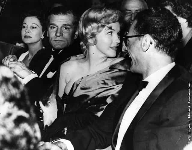 11th October 1956: American actress Marilyn Monroe (1926 - 1962) with her husband playwright Arthur Miller at the first night of his play A View From The Bridge, with Sir Laurence Olivier and his wife Vivien Leigh