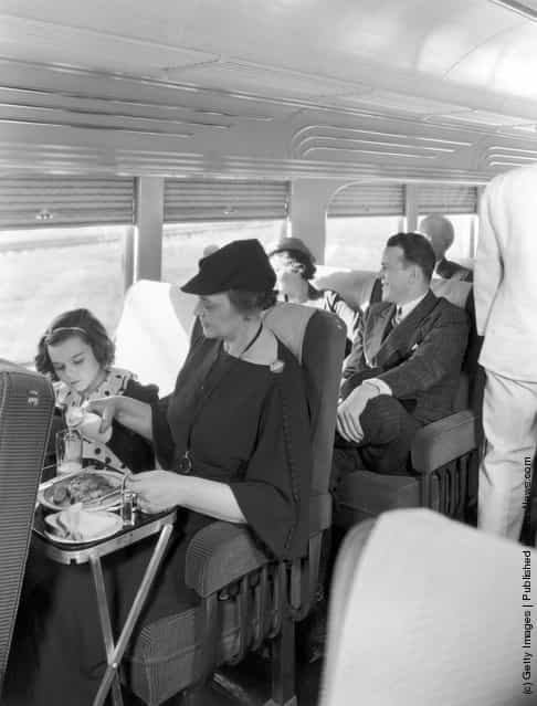 Passengers relaxing with a cooked meal on the Illinois Central streamline diesel train Green Diamond, circa 1935