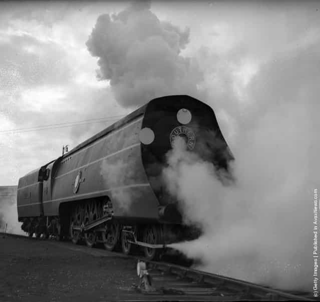 1941: Dressed in an engine drivers cap and overalls, the Minister of Transport, Moore-Brabazon, drove the Southerns new streamlined engine, named the Channel Packet, on a trial run from its yard