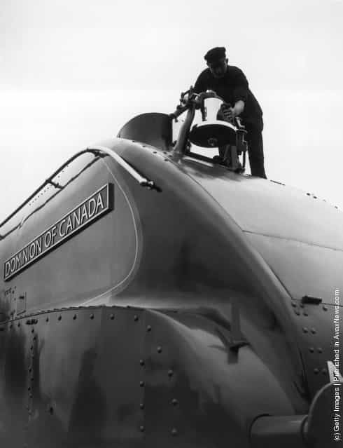 1937: The streamlined class A4 Pacific locomotive Dominion of Canada seen at Kings Cross, London, equipped with a locomotive bell of the standard type used in Canada. The bell completes the all-Canadian equipment of the locomotive
